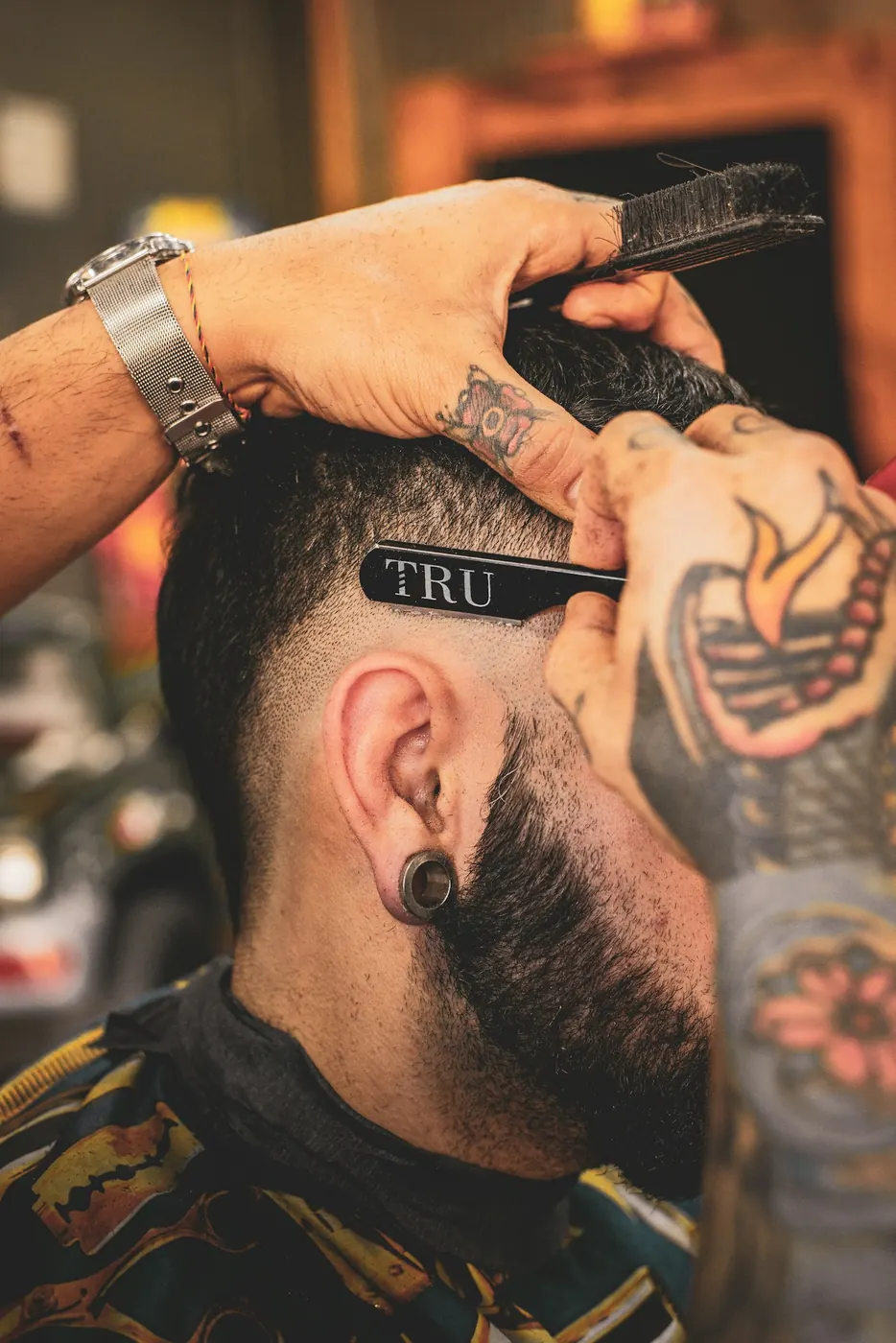 Barber shaping a beard with a straight razor