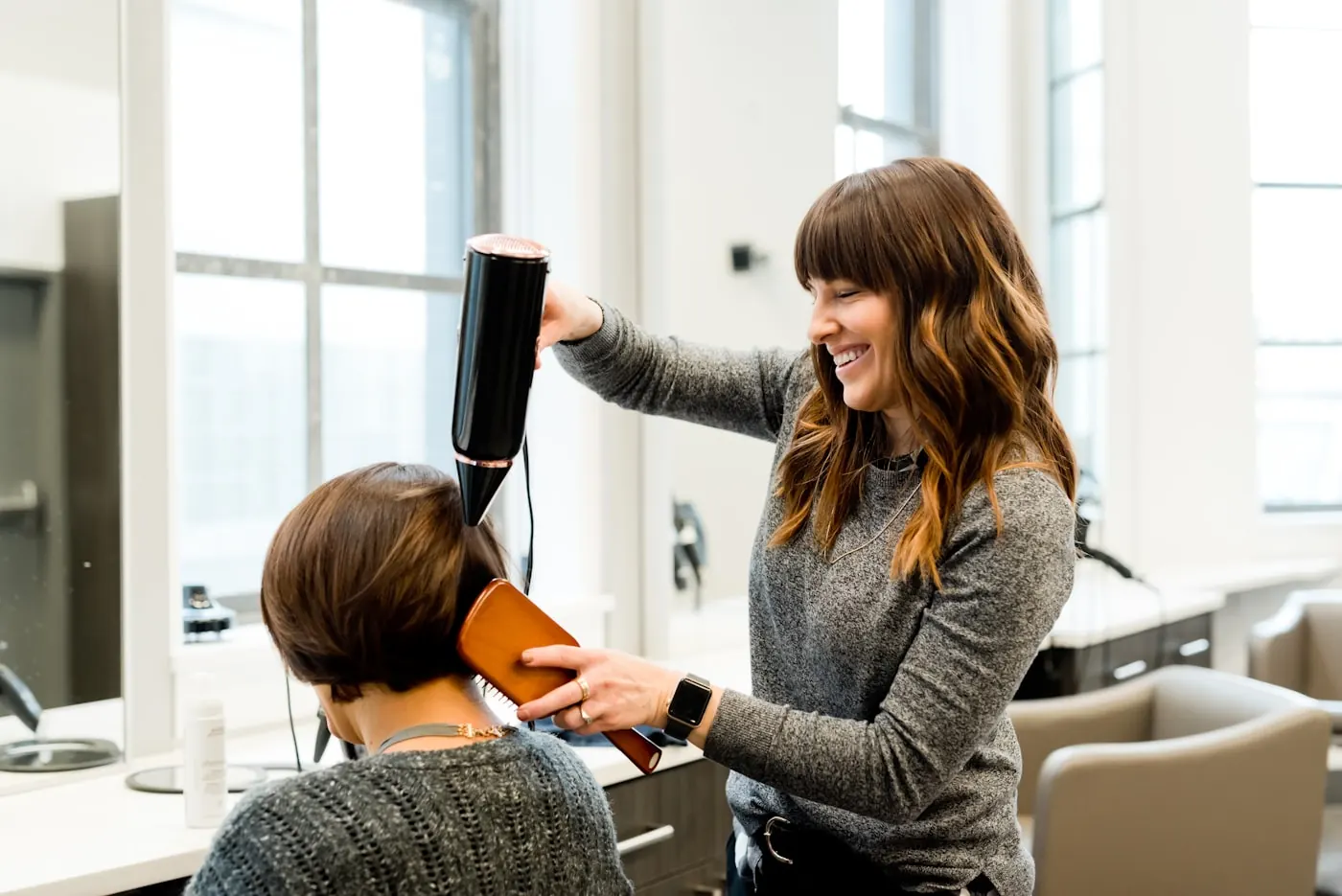 Stylist blow-drying hair section by section
